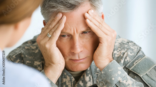 Middle aged retired soldier receiving psychological treatment