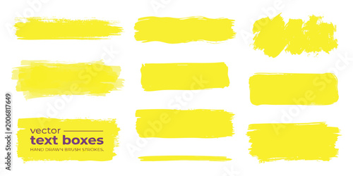 Foto Set of yellow hand drawn paint brush strokes and text boxes for design elements