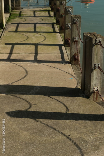 Harbor with shadows on the footpath