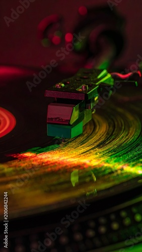 Vinyl record spinning with colorful light reflections