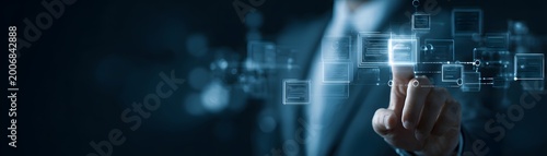 A business professional interacts with a digital interface, highlighting innovation and technology trends