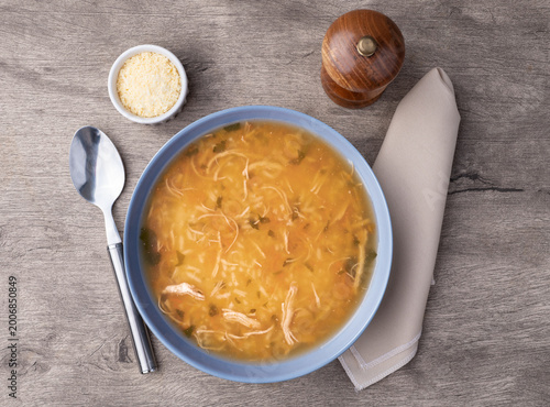 Chicken soup in over wooden table