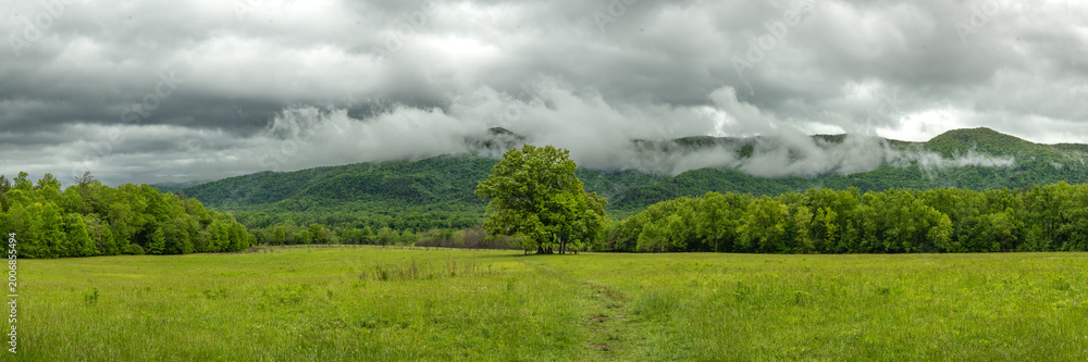 Fototapeta premium Rain Clouds Gather Over An Open Field In Cades Cove