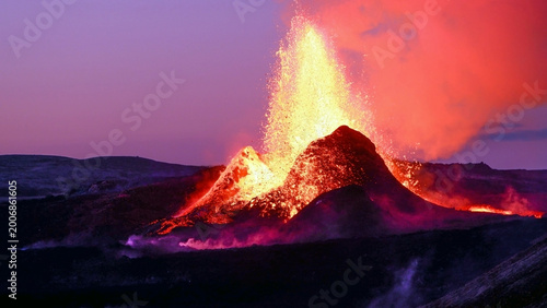 Schilderij op canvas Volcanic eruption with glowing lava fountain at dusk dramatic Iceland landscape