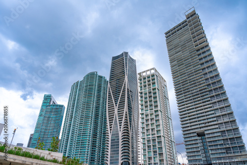 Modern high rise skyscrapers and luxury condominiums in downtown Miami. Architectural view of glass skyscrapers including One Thousand Museum under a cloudy sky in Miami.