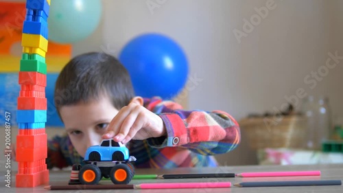 Boy Using Toy Monster Truck to Topple Colorful Building Block Tower — Dynamic Indoor Play Video Capturing Childhood Imagination, Creative Learning, and Motor Skill Development