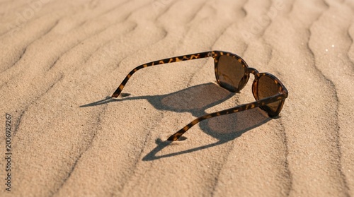 designer sunglasses casting shadow on white fabric isolated on transparent background