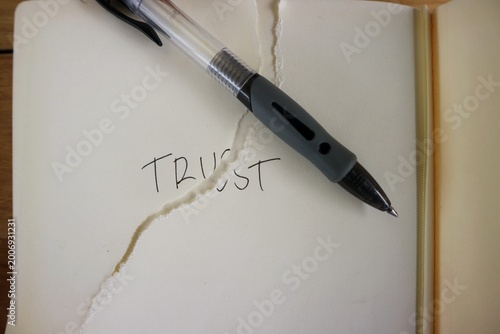 Photography The tear of the paper right in the middle of the word TRUST conveys a profound visual message