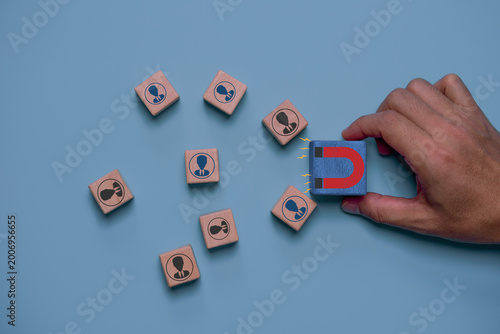 Customer retention strategy concept with magnet attracting user icons represent loyalty, client engagement, relationship management, repeat business, brand trust and long term customer value.