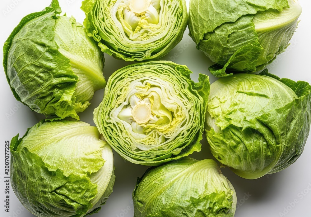 Fototapeta premium Overhead shot of fresh iceberg lettuce heads arranged tightly on a white background, highlighting crisp green leaves and crunchy texture, grocery, salad, leafy