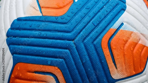Close up view of professional soccer ball surface with water droplets.