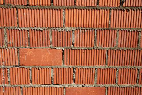 Tableau sur toile Brick wall construction with red clay bricks during daylight at a construction s