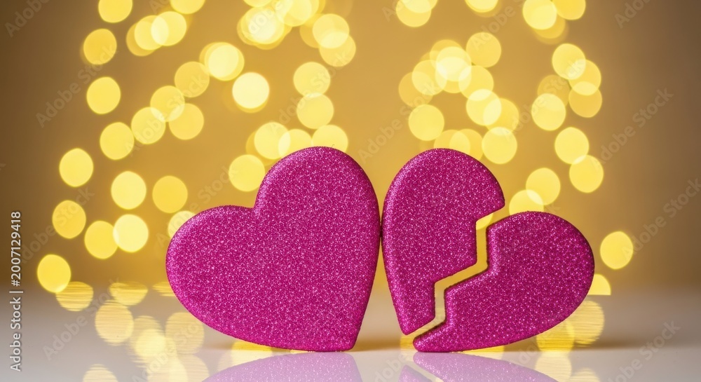 Obraz premium Two glittery pink hearts with one broken in half on a white surface illustration