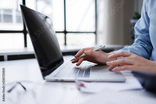 Photos Businesswoman hands on a laptop using pen and trackpad, typing and navigating fo