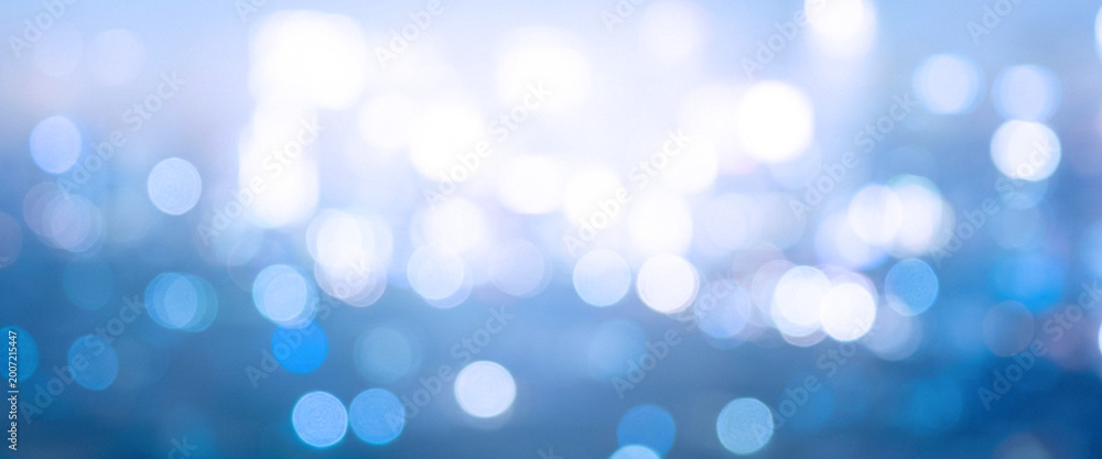Fototapeta premium A soft and dreamy abstract background featuring blurred blue lights creating a tranquil atmosphere, perfect for use in various design projects.