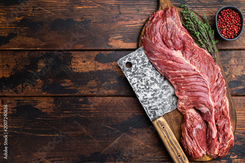 Tableau sur toile Raw beef hanger steak or onglet on wooden board with cleaver peppercorn and herb