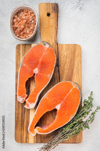 Canvas Print Raw chum salmon steaks also known as pink salmon on wooden board with thyme and