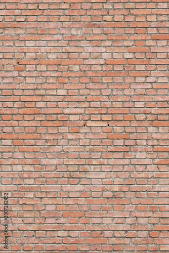 Red brick wall surface with textured pattern