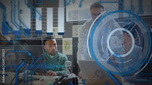Senior pointing at laptop, guiding tech team reviewing code while transparent HUD overlaying laptop