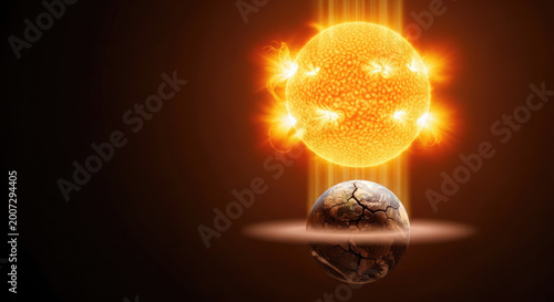 Fiery sun intensely radiating heat and light down onto a parched cracked and barren planet earth symbolizing global warming crisis climate change and environmental catastrophe