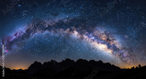Milky way galaxy arches over dark mountain silhouette at night stunning astrophotography