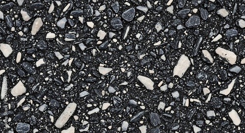 Close-up Texture of Dark Asphalt with White and Gray Stone Inclusions.