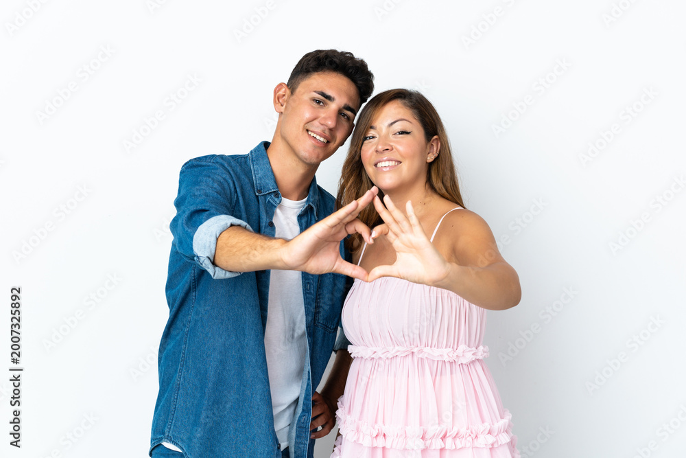 Naklejka premium Young caucasian couple isolated on white background making a heart with hands