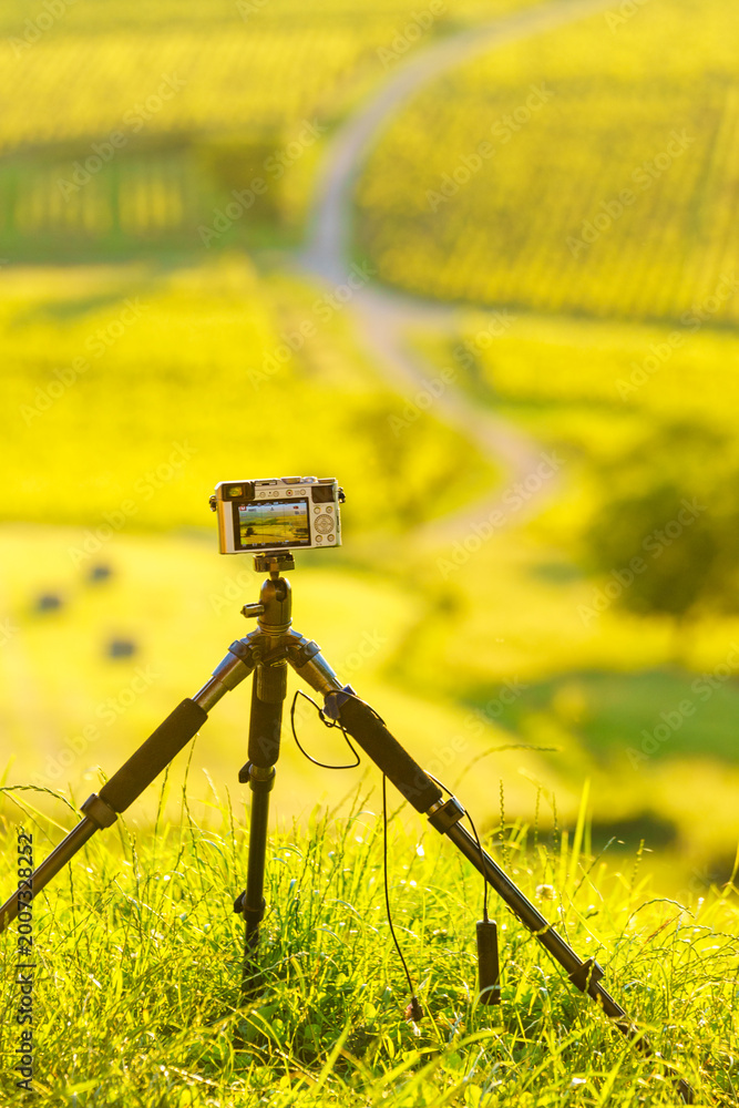 Naklejka premium Camera on tripod take picture from landscape in Pupillin commune, Jura wine region, Burgundy in France.