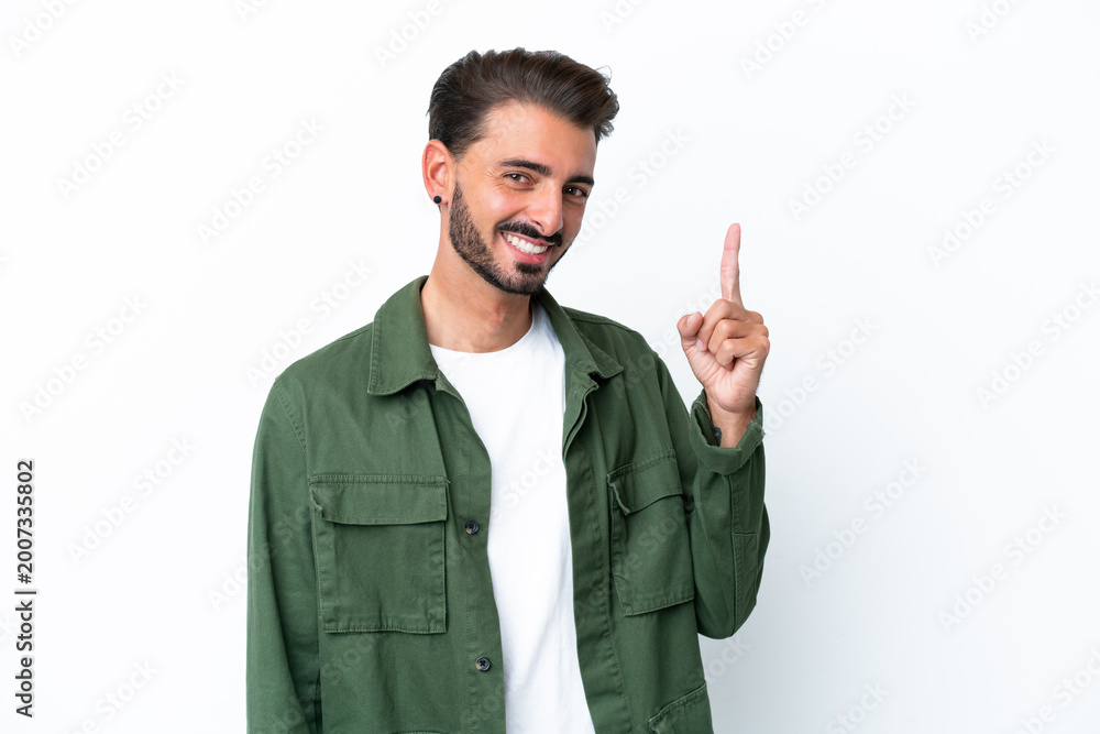 Fototapeta premium Young caucasian man isolated on white background showing and lifting a finger in sign of the best