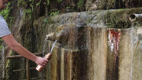 Raw 4K footage of a person drinking fresh water from a mountain spring pipe, showing natural source, clean drinking water, and rural lifestyle in Uttarakhand India.