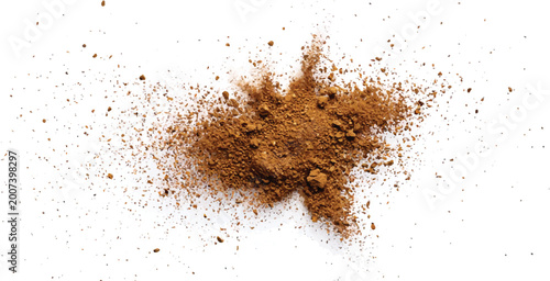 Fotografie A cloud of brown powder and particles exploding outwards with white background e