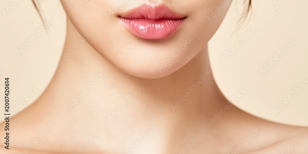 Obraz premium Close-up of a young Korean woman's smooth, glossy lips and jawline