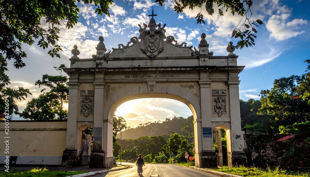 Fototapeta premium Ornate archway leading to sunlit hills with a lone figure walking
