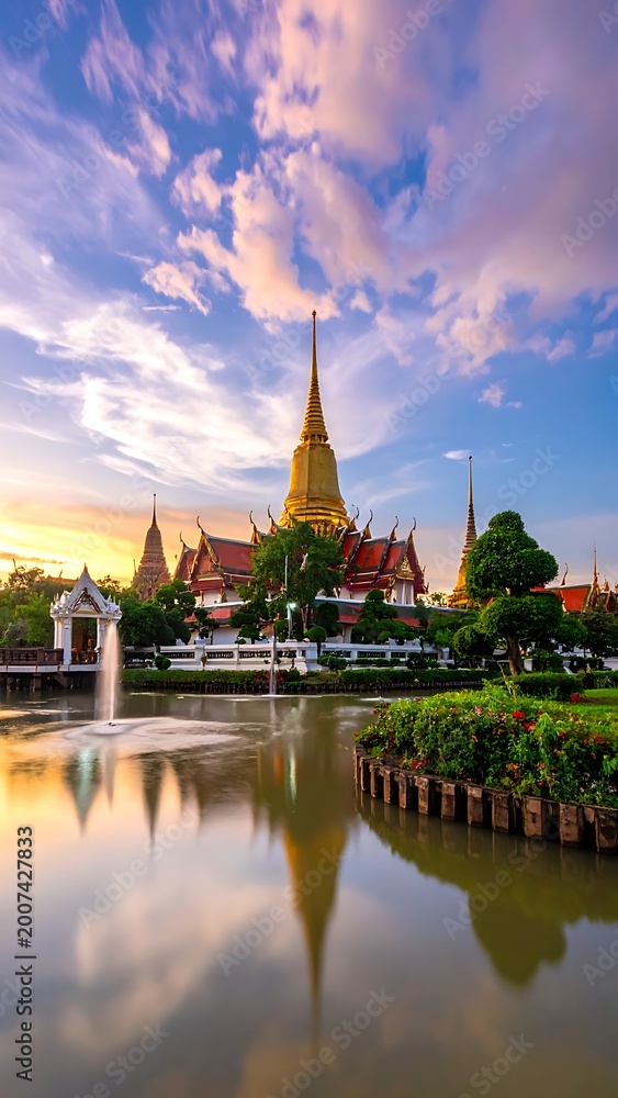 Fototapeta premium Golden temple by serene lake at sunset