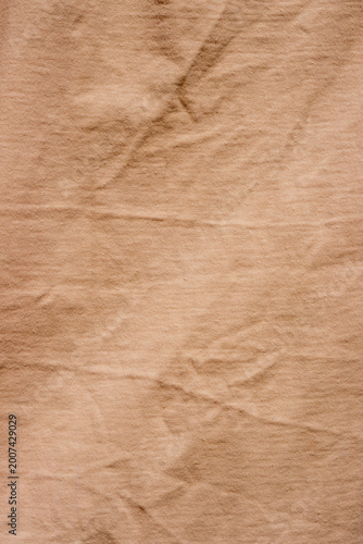 The surface of a pastel orange crew neck t-shirt.