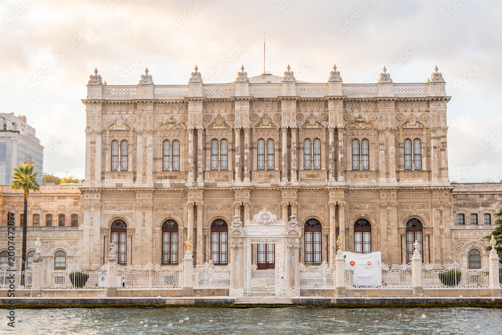 Fototapeta premium The magnificent facade of the Dolmabahçe Palace seen from the Bosphorus, showcasing its ornate Ottoman architecture and white marble detail.