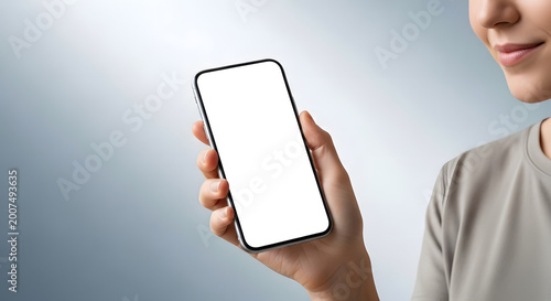 Woman holding smartphone with blank screen against gradient background