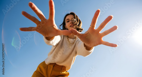 Woman reaching out with open hands against blue sky transparent background
