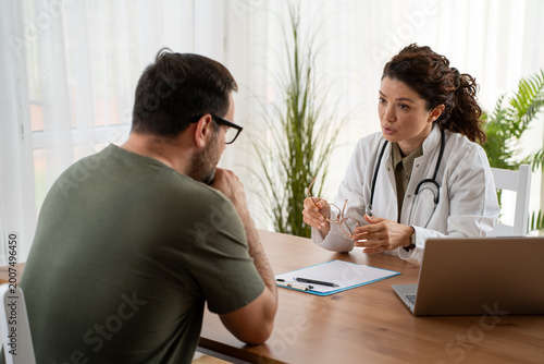 Doctor comforting patient during consultation in medical clinic office
