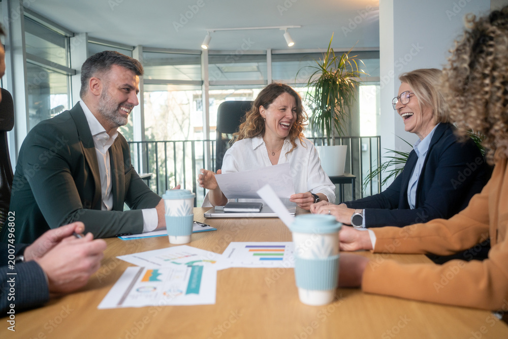 Fototapeta premium Happy multicultural colleagues in business meeting after achieving success