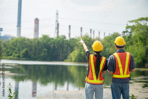 Obraz na płótnie Environmental assessment meeting industrial site people observing natural surrou