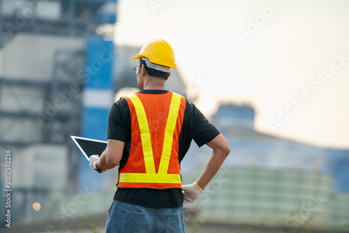 Construction worker engaged in project management industrial site digital interaction daytime professional perspective