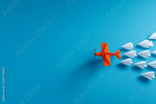 Leadership concept, Orange leader plane leading white plane, on blue background
