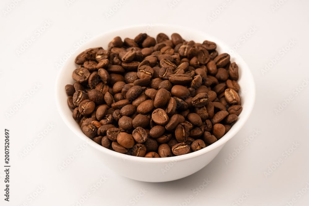 Fototapeta premium Coffee beans on a white background. Top view. Coffee beans texture.