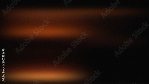 Fotografie Blurry orange light streaks on dark background with glowing effect