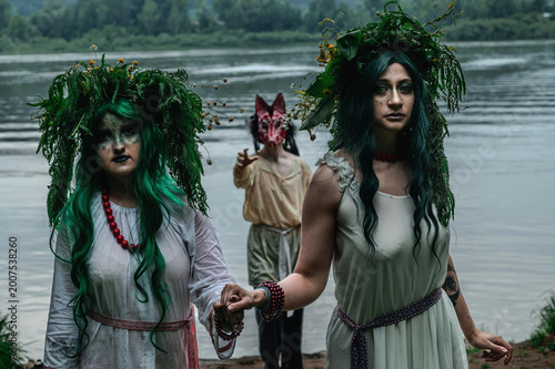Rusalka in white with a wreath on her head and green hair