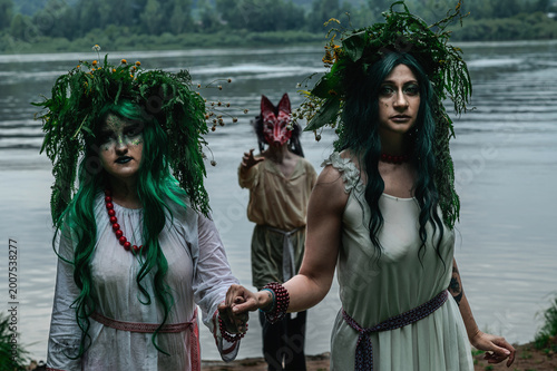 Rusalka in white with a wreath on her head and green hair