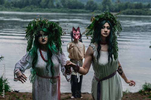 Rusalka in white with a wreath on her head and green hair
