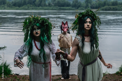 Rusalka in white with a wreath on her head and green hair
