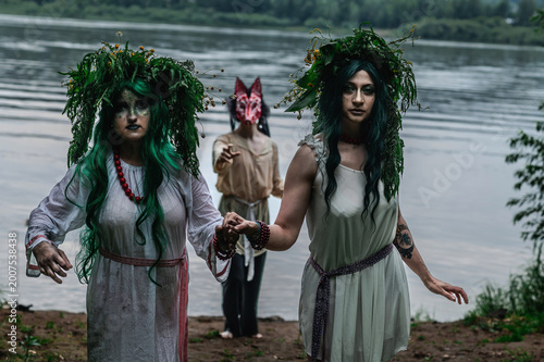 Rusalka in white with a wreath on her head and green hair